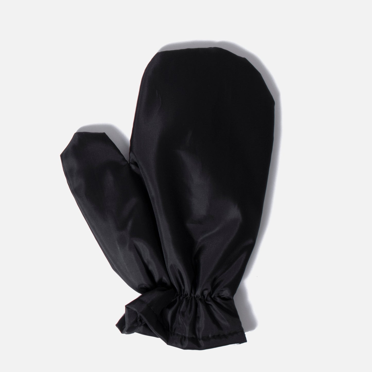 The Fridja Heatproof Glove is a black, heat-resistant glove with an elastic wrist band, shown flat on a light gray background; ideal for use with clothes steamers.