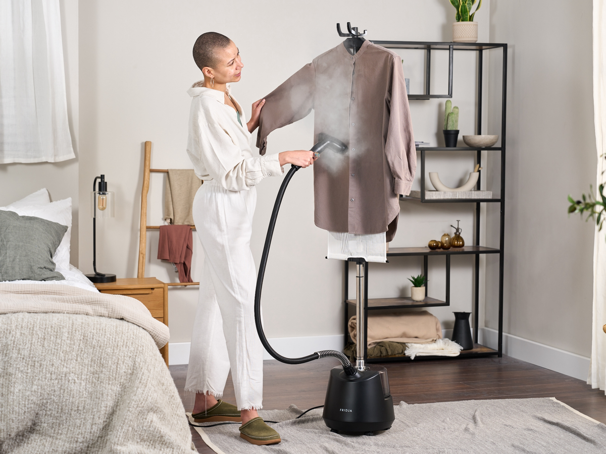 Fridja f1200 Clothes Steamer Pro in a bedroom