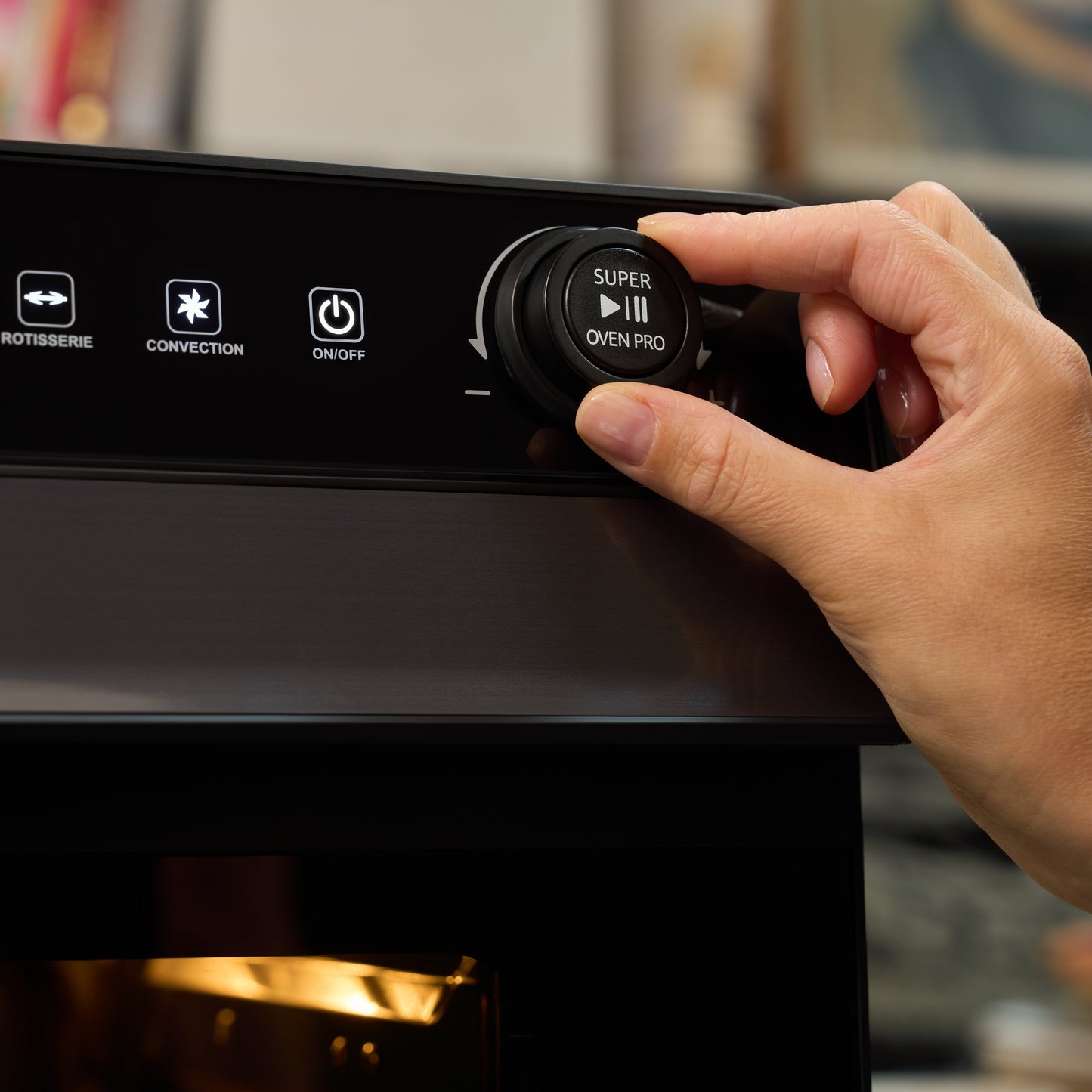 A hand turns a dial on the Fridja f77 Super Oven Pro - 30L Digital Air Fryer Oven, showing buttons labeled “Rotisserie,” “Convection,” and “On/Off” on its sleek control panel.