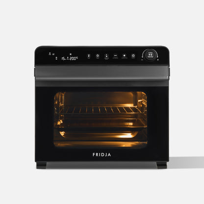 The Fridja f77 Super Oven Pro is a 30L black digital air fryer oven with easy controls, a glass door with interior lighting, a wire rack, PFAS-free materials, and the Fridja logo on the front.