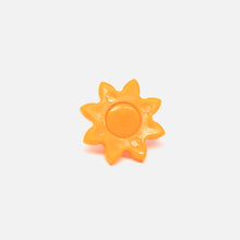 A Fridja f1900 Orange Gear Cog, a plastic sun-shaped juicer component with a round center and pointed rays, is shown on a plain white background.