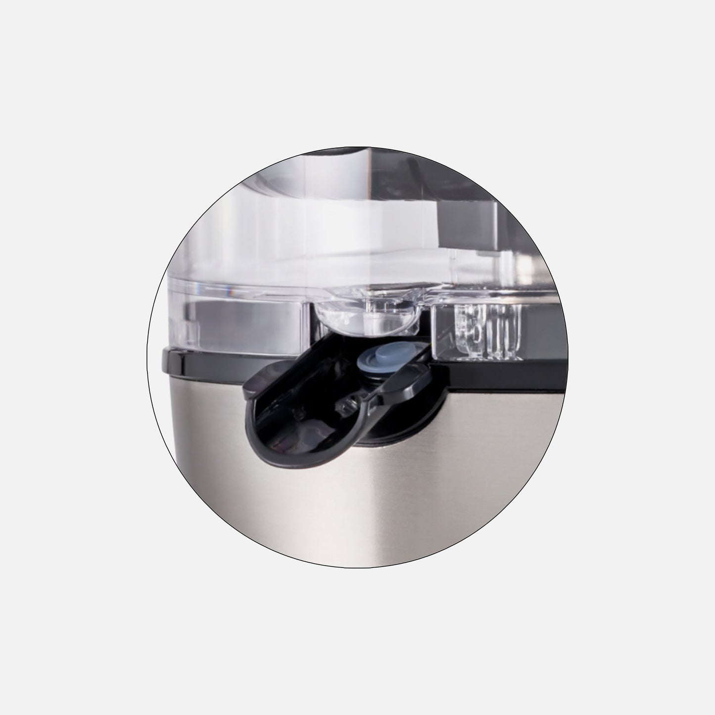 Close-up of a Fridja Anti Drip Spout on a stainless steel appliance, slightly open to dispense juice.